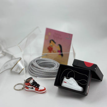 Stylish Rakhi hamper with custom keychain, pendant, and lace