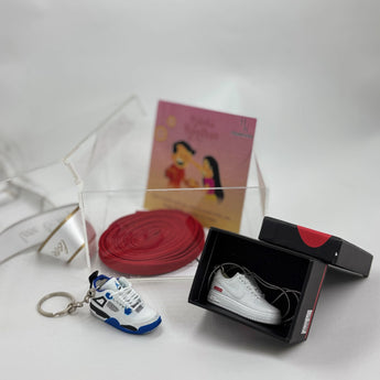 Stylish Rakhi hamper with custom keychain, pendant, and lace