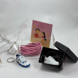 Stylish Rakhi hamper with custom keychain, pendant, and lace